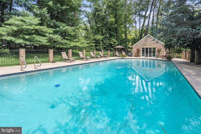 view of pool featuring an outdoor structure and a patio