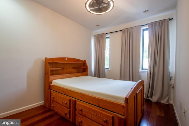 bedroom with dark wood-type flooring