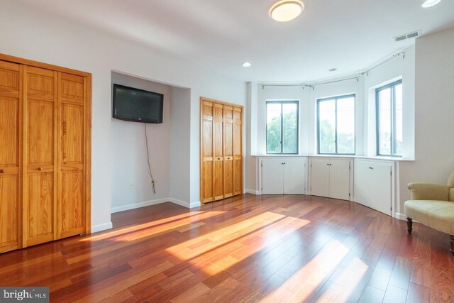 unfurnished bedroom with hardwood / wood-style flooring