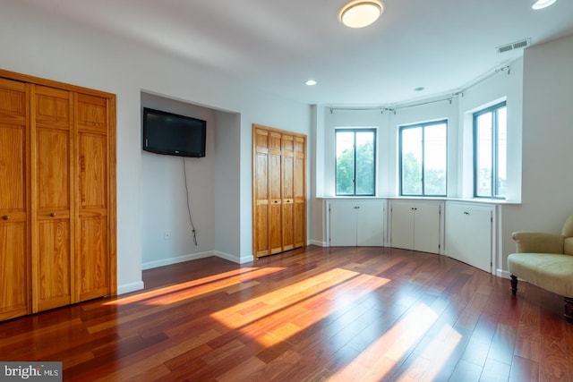 unfurnished bedroom with dark hardwood / wood-style flooring