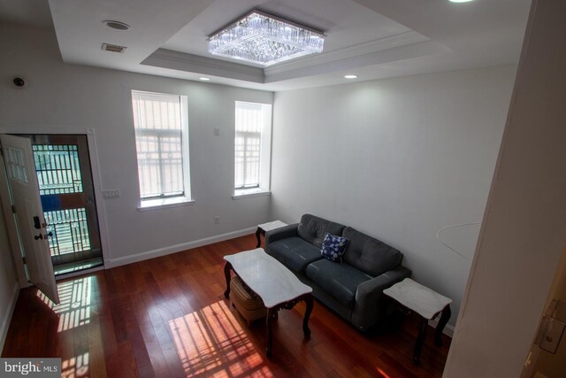 sitting room featuring a tray ceiling and dark hardwood / wood-style flooring