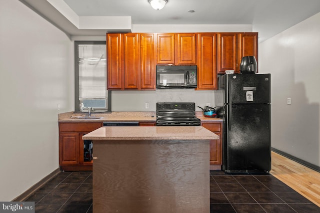 kitchen featuring black appliances, a kitchen island, sink, and dark wood-type flooring