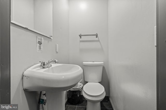 bathroom with toilet and tile patterned floors