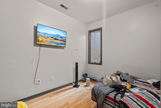 bedroom with hardwood / wood-style flooring