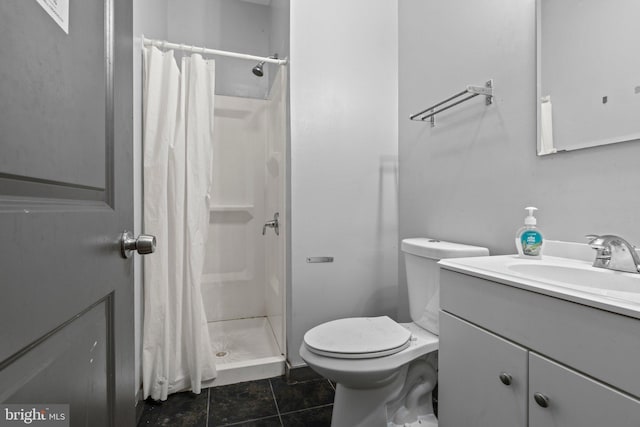 bathroom with tile patterned floors, a shower with shower curtain, toilet, and vanity