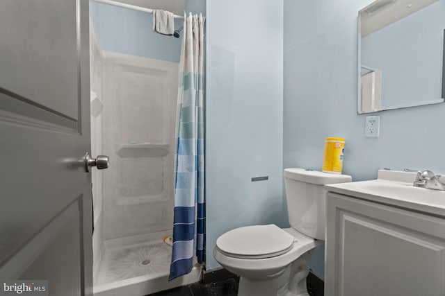 bathroom featuring vanity, toilet, and a shower with shower curtain