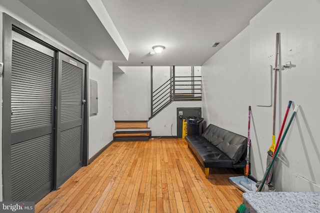 interior space featuring electric panel and light wood-type flooring