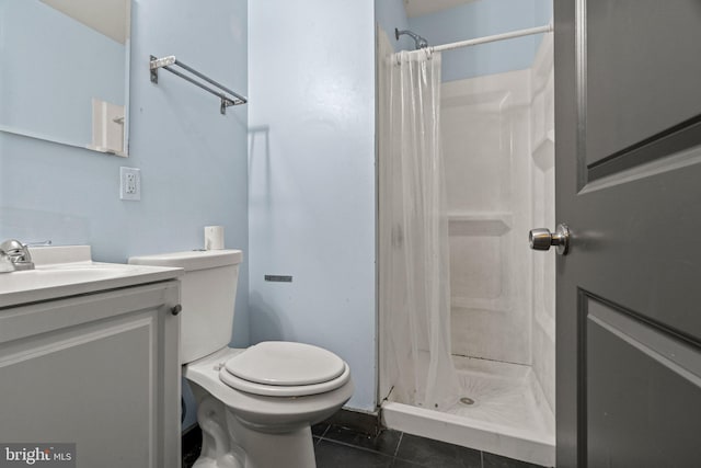 bathroom featuring vanity, toilet, curtained shower, and tile patterned floors