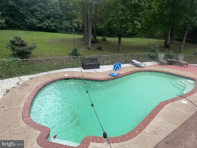 view of pool featuring a fenced in pool, a patio, fence, and a lawn