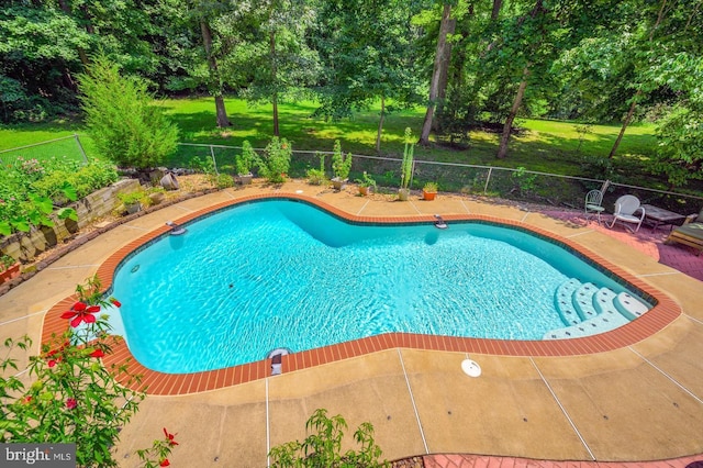 view of swimming pool with a fenced backyard, a fenced in pool, a lawn, and a patio