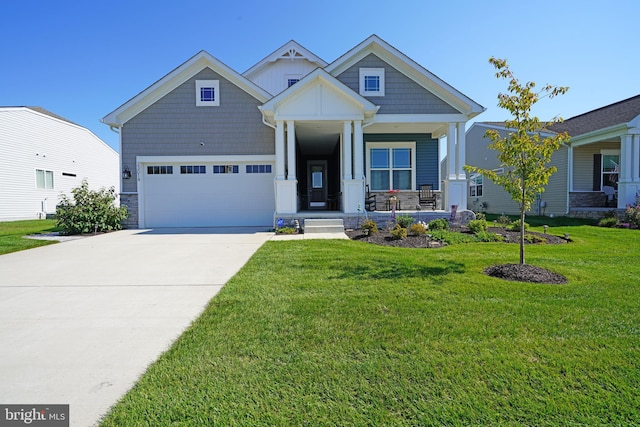 craftsman-style home with a garage, a porch, and a front lawn