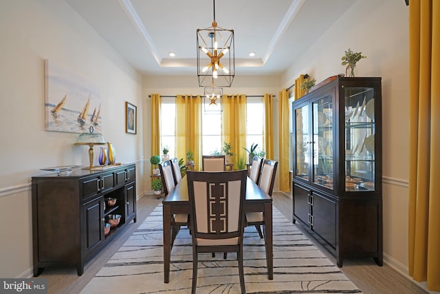 dining room with a chandelier and a tray ceiling