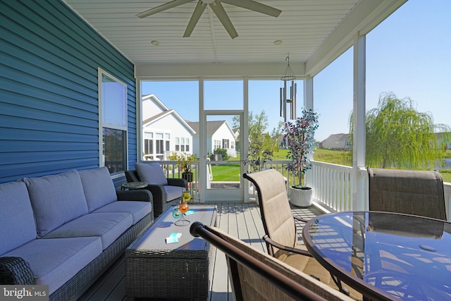 sunroom / solarium featuring ceiling fan