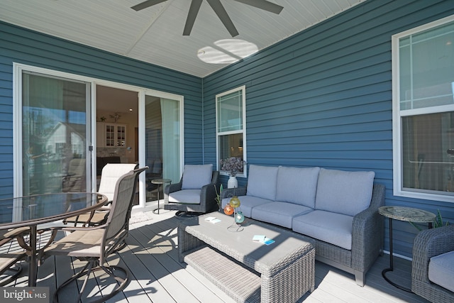 wooden terrace featuring ceiling fan and an outdoor hangout area