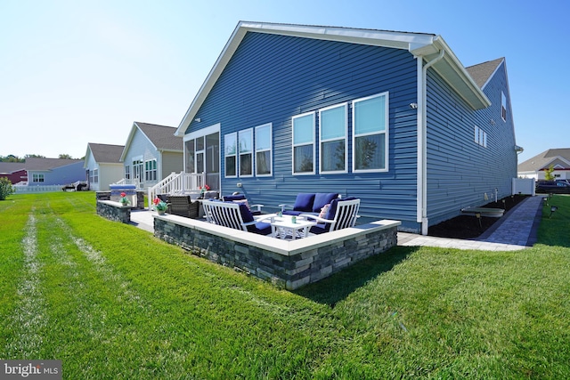 back of house with a yard and a fire pit