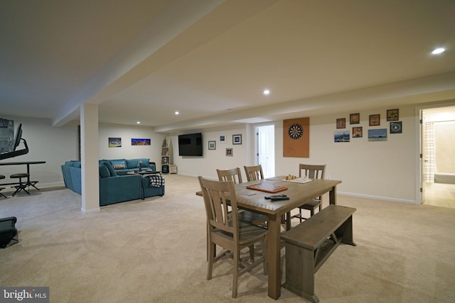 dining area with plenty of natural light and light colored carpet