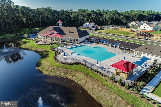 view of pool with a water view and a patio