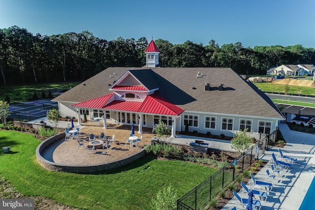 back of property with a yard, an outdoor living space, a patio area, and a swimming pool