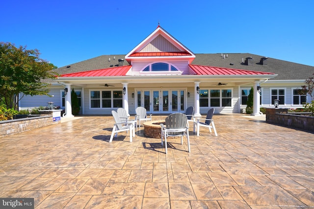 back of property with an outdoor fire pit and a patio area