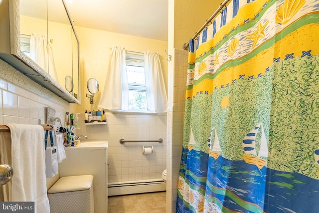 full bath with vanity, tile walls, a shower with curtain, and baseboard heating