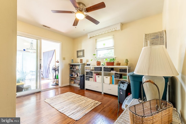 rec room featuring visible vents, baseboards, wood finished floors, and a ceiling fan