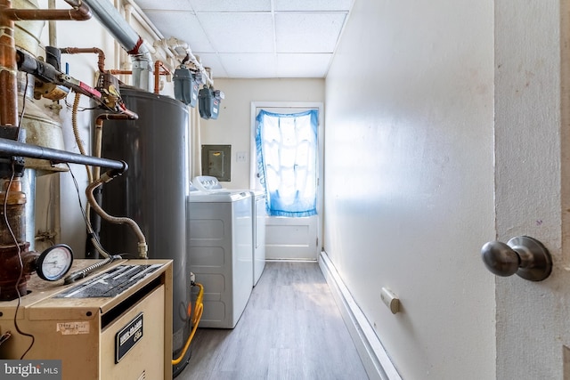 laundry area with light wood finished floors, baseboards, electric panel, laundry area, and separate washer and dryer
