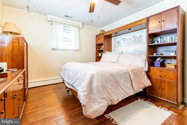bedroom featuring visible vents, a baseboard radiator, light wood-style flooring, ceiling fan, and ornamental molding