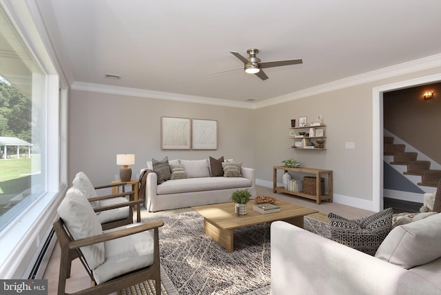 living room featuring carpet flooring, a baseboard heating unit, ceiling fan, and ornamental molding