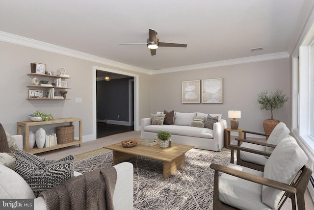 living room with visible vents, baseboards, crown molding, and ceiling fan