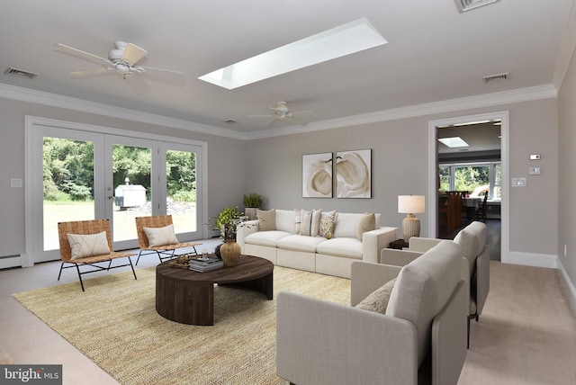 living area with a skylight, visible vents, and ornamental molding