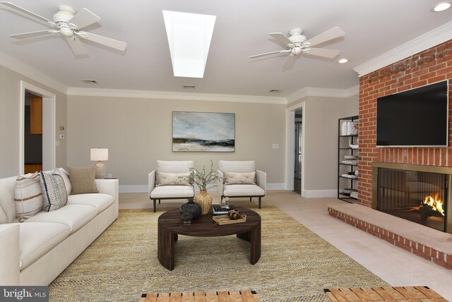 living room with light carpet, ornamental molding, a brick fireplace, and ceiling fan