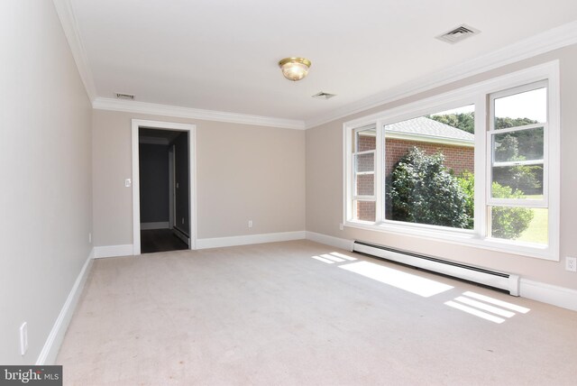 spare room with crown molding, baseboard heating, and carpet