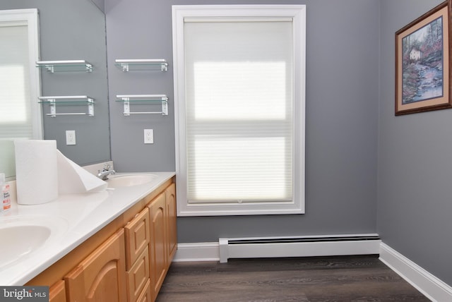 bathroom featuring vanity, baseboard heating, and hardwood / wood-style floors