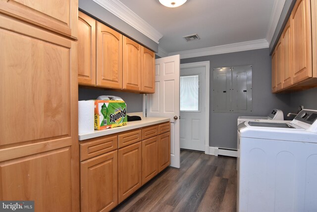 laundry room featuring ornamental molding, dark wood-type flooring, cabinets, and washer and dryer