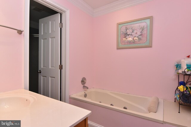 bathroom with a tub to relax in, vanity, and crown molding