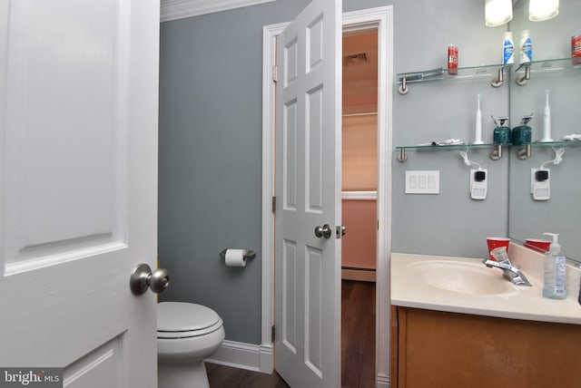 bathroom with vanity, a baseboard radiator, wood-type flooring, toilet, and ornamental molding