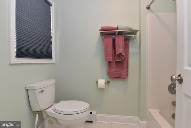 full bathroom featuring toilet, tile patterned flooring, baseboards, baseboard heating, and shower / bathtub combination