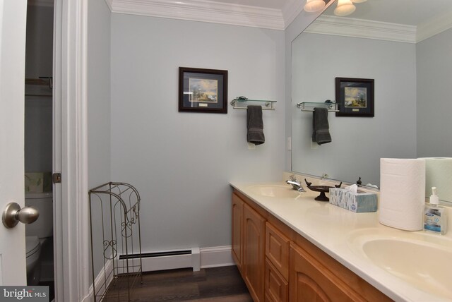 bathroom with vanity, a baseboard radiator, hardwood / wood-style floors, toilet, and ornamental molding