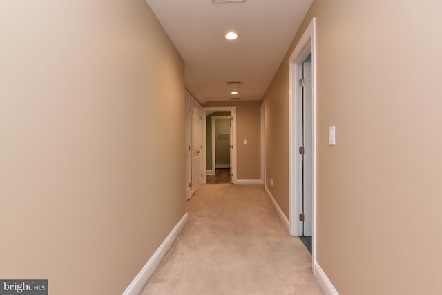 hall with recessed lighting, visible vents, baseboards, and light carpet