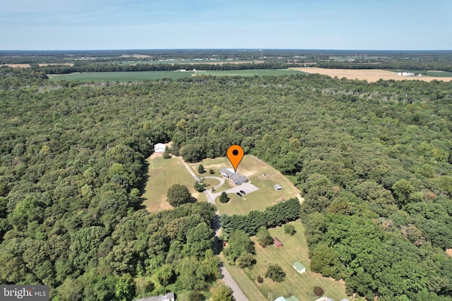 birds eye view of property with a wooded view