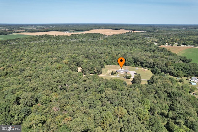 drone / aerial view featuring a forest view