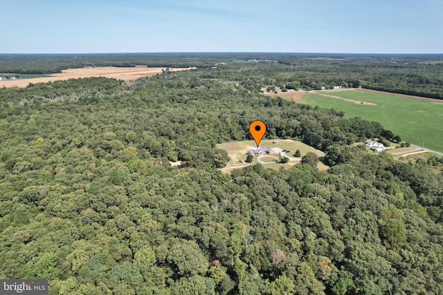 drone / aerial view featuring a wooded view