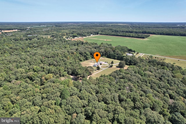 birds eye view of property featuring a view of trees and a rural view