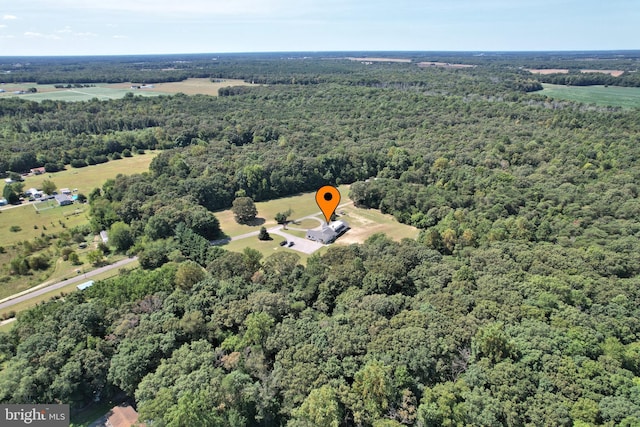 birds eye view of property with a view of trees