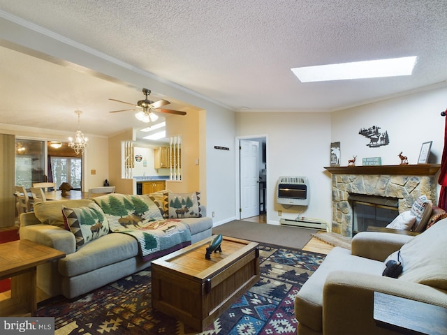 living room with a fireplace, heating unit, a baseboard heating unit, ceiling fan with notable chandelier, and a textured ceiling