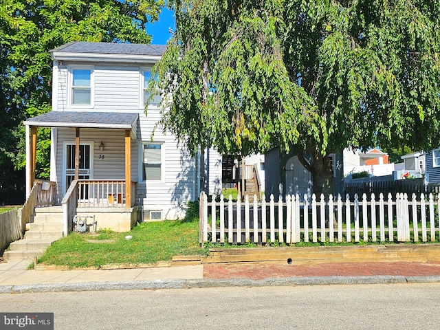 view of property hidden behind natural elements with a porch