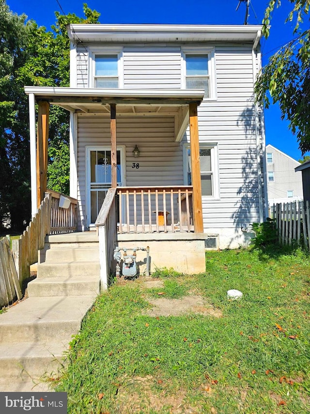 view of front of home featuring a front yard and a porch