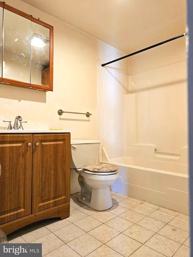 bathroom featuring tile patterned flooring, tub / shower combination, toilet, and vanity