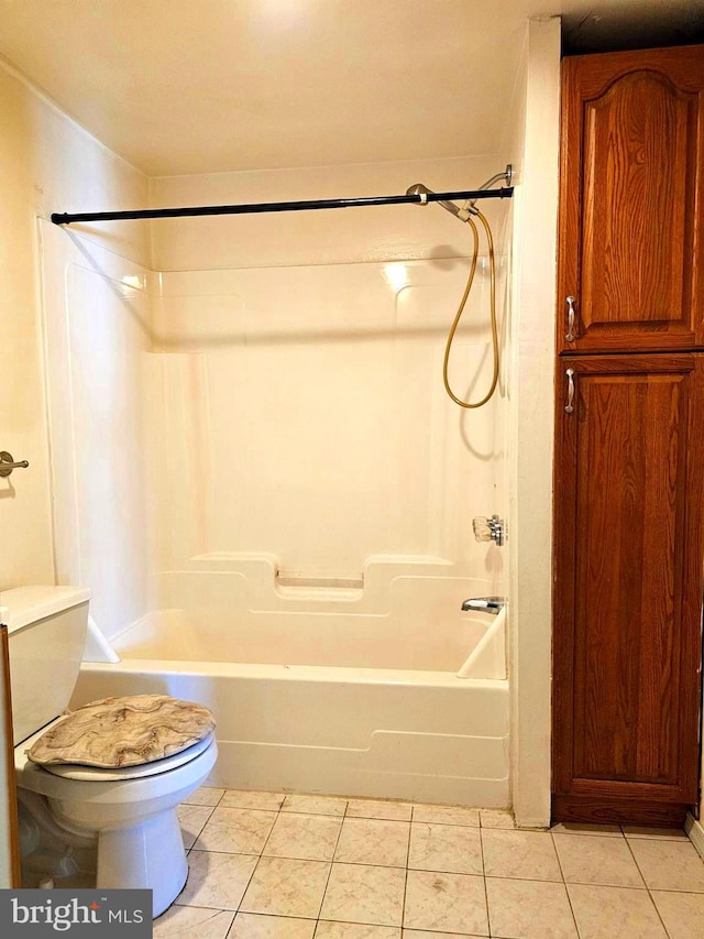 bathroom featuring tile patterned floors, toilet, and shower / bath combination