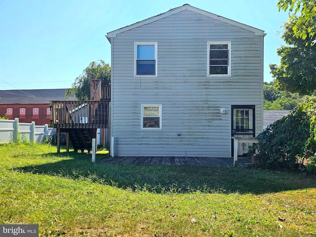 back of house with a yard, fence, and a wooden deck